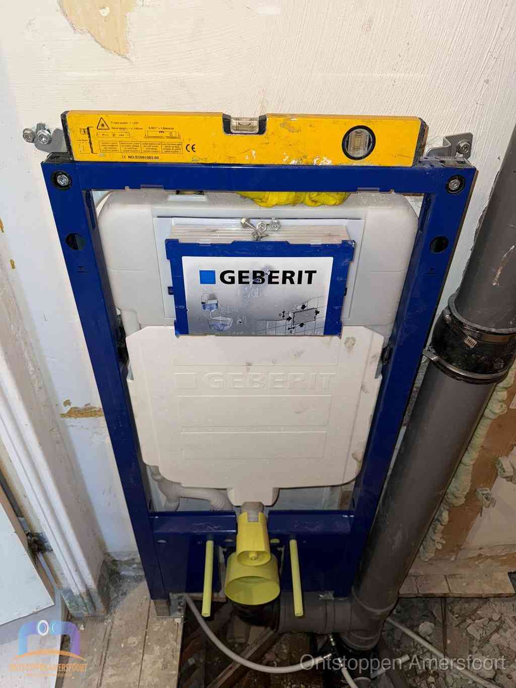 Een Geberit inbouwreservoir met frame voor een hangtoilet tegen de wand, met de afvoerbocht naar de vloer, kenmerkend voor een verstopt hangtoilet in Amersfoort